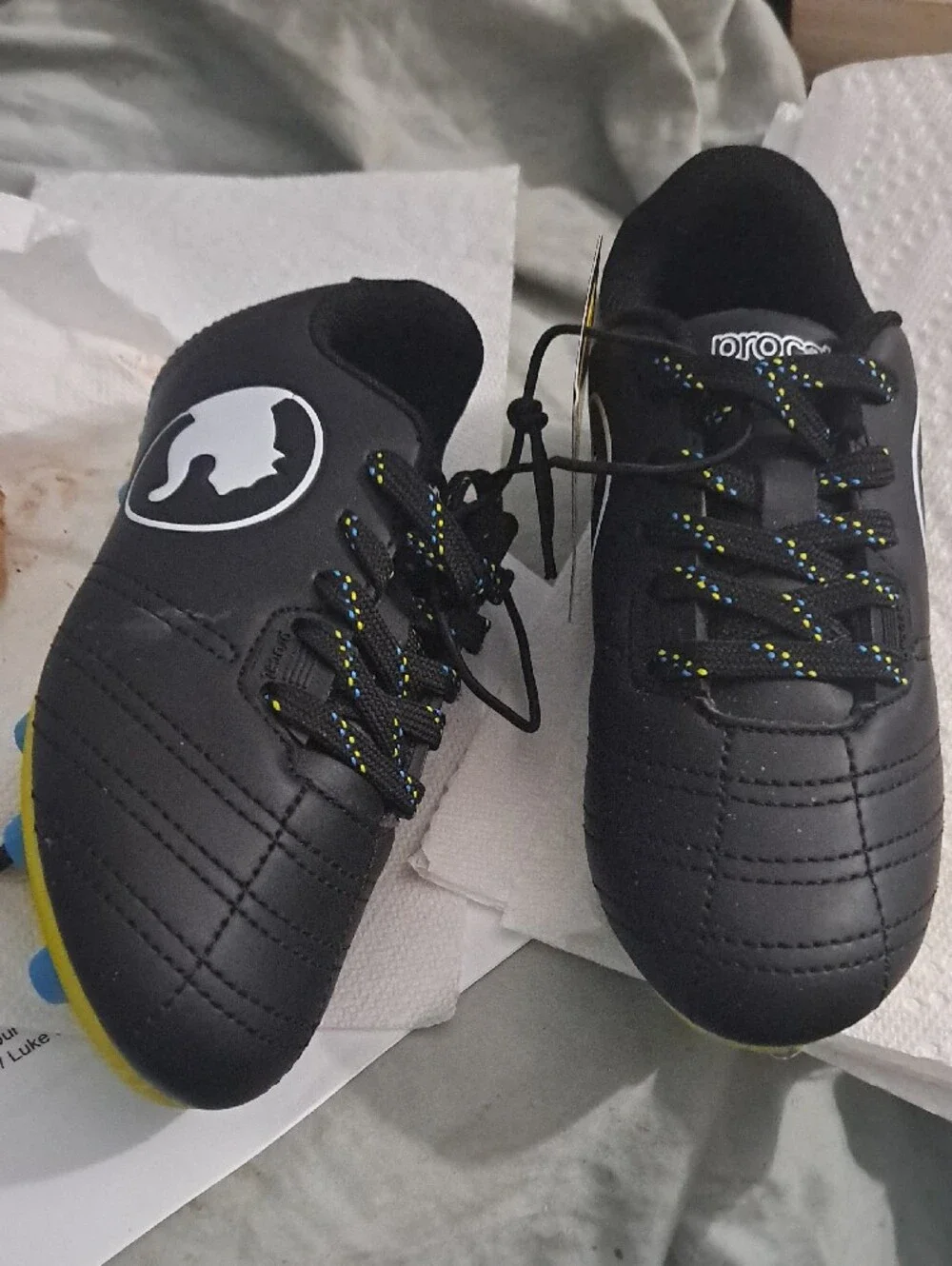 Puma Kids Black Soccer Cleats with Yellow Sole and Blue Studs